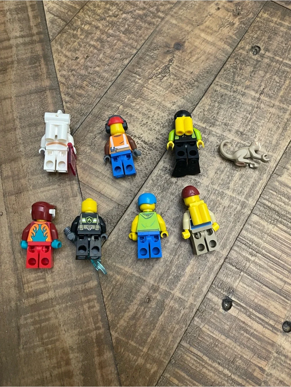 collection of assorted used LEGO minifigures and a toy monkey